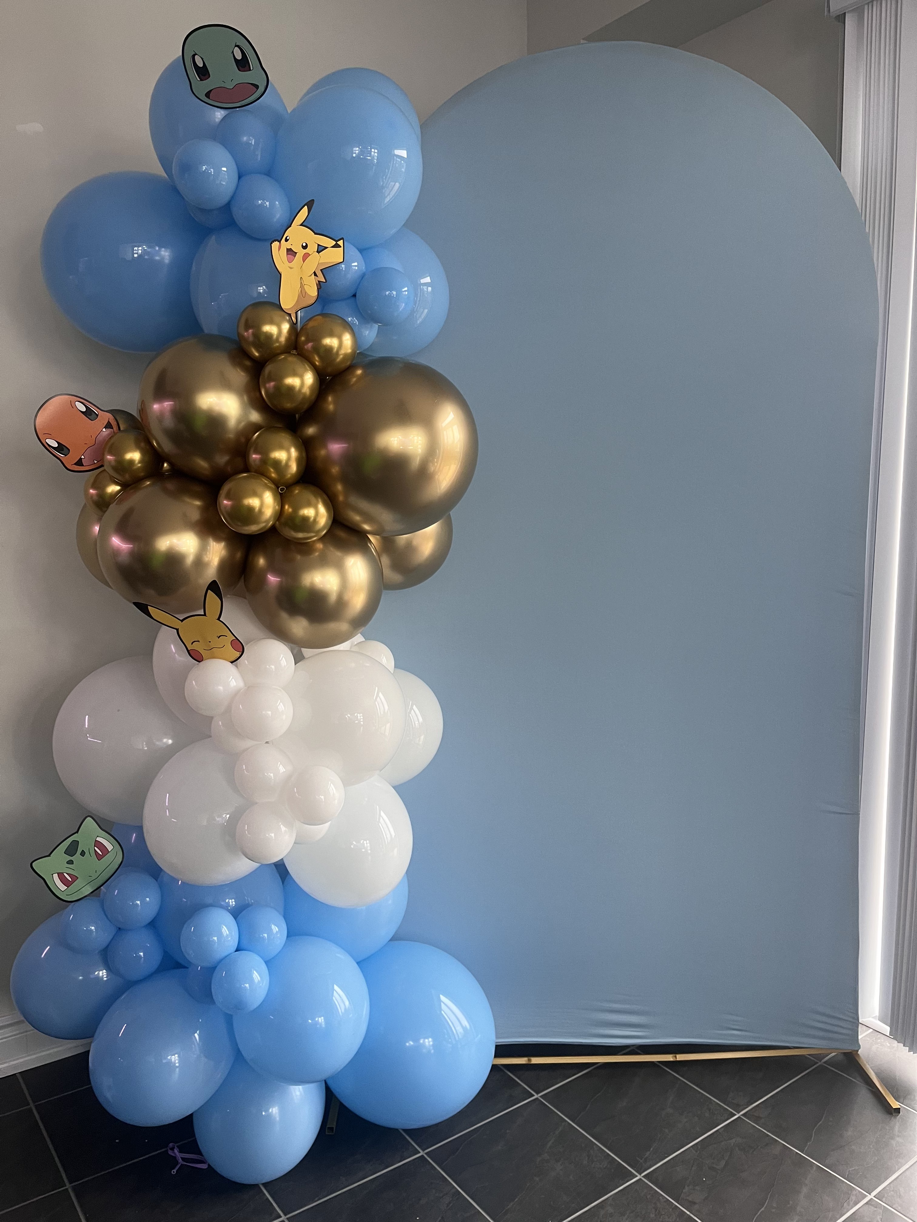 Birthday dessert table with pastel balloon garland